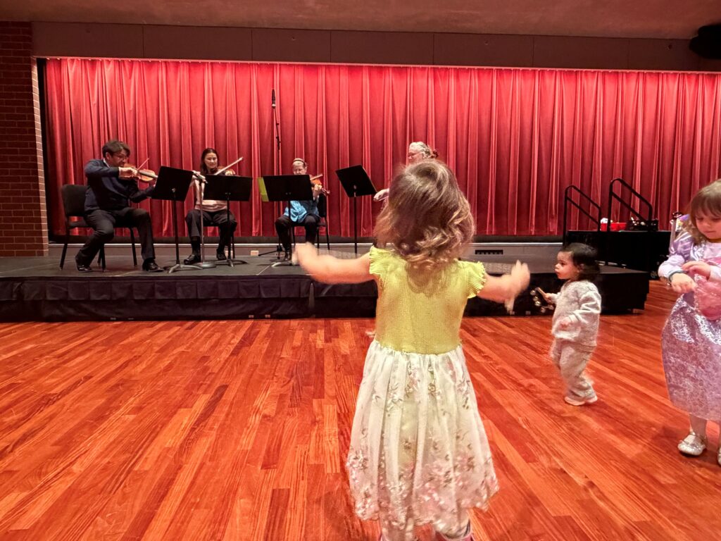 child conducting orchestra